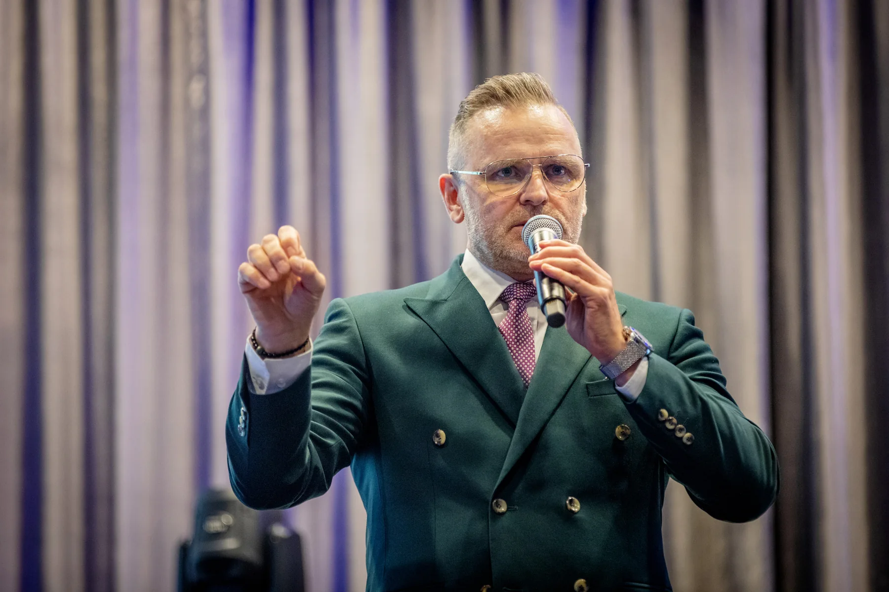 Paweł Piotr Nowak z mikrofonem na scenie